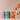 Four cans of Curatif in a row with a hand reaching down to pick up the can on the far right